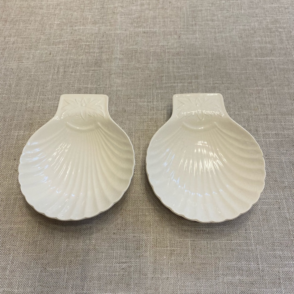 Two scalloped shell shaped dishes/plates.